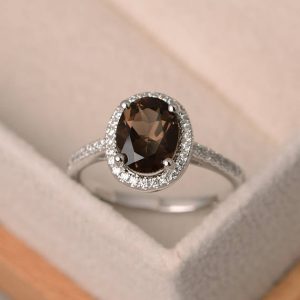 Shop Smoky Quartz Jewelry! Smoky quartz ring, oval gemstone ring, sterling silver halo ring, oval engagement ring, promise ring | Natural genuine Smoky Quartz jewelry. Buy handcrafted artisan wedding jewelry.  Unique handmade bridal jewelry gift ideas. #jewelry #beadedjewelry #gift #crystaljewelry #shopping #handmadejewelry #wedding #bridal #jewelry #affiliate #ad