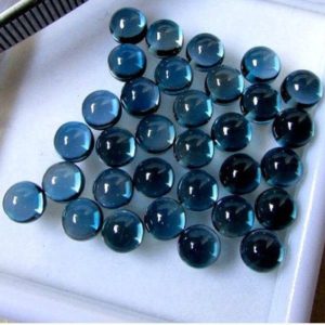 Shop Topaz Stones & Crystals! AAA London Blue Topaz Round cabochon 5X5MM Natural London Blue Topaz Round Cabochon Calibrated Size Loose Gemstone for Jewelry | Natural genuine stones & crystals in various shapes & sizes. Buy raw cut, tumbled, or polished gemstones for making jewelry or crystal healing energy vibration raising reiki stones. #crystals #gemstones #crystalhealing #crystalsandgemstones #energyhealing #affiliate #ad