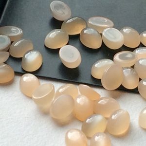 Shop Moonstone Cabochons! 4x6mm Peach Moonstone Plain Oval Cabochon, Oval Plain Calibrated Flat Back Peach Moonstone, Moonstone For Jewelry (10Pcs To 100Pcs Options) | Natural genuine stones & crystals in various shapes & sizes. Buy raw cut, tumbled, or polished gemstones for making jewelry or crystal healing energy vibration raising reiki stones. #crystals #gemstones #crystalhealing #crystalsandgemstones #energyhealing #affiliate #ad