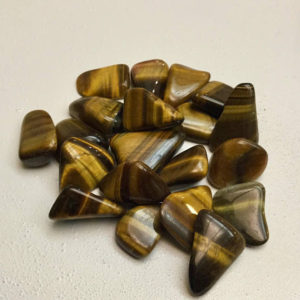 Shop Tumbled Tiger Eye Crystals & Pocket Stones! Polished Natural Striped Loose Sharks Tooth Shaped Tigers Eye Gemstones Featuring Elegantly Smooth Finish | Natural genuine stones & crystals in various shapes & sizes. Buy raw cut, tumbled, or polished gemstones for making jewelry or crystal healing energy vibration raising reiki stones. #crystals #gemstones #crystalhealing #crystalsandgemstones #energyhealing #affiliate #ad