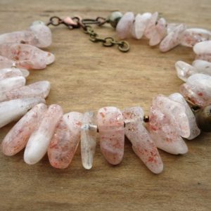 Rustic Pink Sunstone Bracelet, Bohemian tribal jewelry with sparkling pink and white stone spikes and vintage brass bell | Natural genuine Sunstone bracelets. Buy crystal jewelry, handmade handcrafted artisan jewelry for women.  Unique handmade gift ideas. #jewelry #beadedbracelets #beadedjewelry #gift #shopping #handmadejewelry #fashion #style #product #bracelets #affiliate #ad
