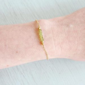 Shop Peridot Bracelets! Green peridot bead bracelet. Tiny peridot rondelle bead bar gemstone bracelet. Peridot beaded bar bracelet. August birthstone bracelet. | Natural genuine Peridot bracelets. Buy crystal jewelry, handmade handcrafted artisan jewelry for women.  Unique handmade gift ideas. #jewelry #beadedbracelets #beadedjewelry #gift #shopping #handmadejewelry #fashion #style #product #bracelets #affiliate #ad