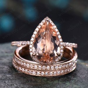 Shop Morganite Jewelry! 8x12mm pear shaped morganite engagement ring set 14k rose gold vintagehalo half eternity diamond promise bridal wedding ring set for women | Natural genuine Morganite jewelry. Buy handcrafted artisan wedding jewelry.  Unique handmade bridal jewelry gift ideas. #jewelry #beadedjewelry #gift #crystaljewelry #shopping #handmadejewelry #wedding #bridal #jewelry #affiliate #ad