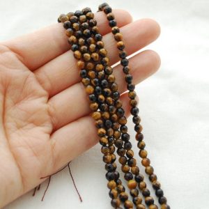 Shop Tiger Eye Faceted Beads! High Quality Grade A Natural Tiger Eye Semi-Precious Gemstone FACETED Round Beads – 4mm – 15" strand | Natural genuine faceted Tiger Eye beads for beading and jewelry making.  #jewelry #beads #beadedjewelry #diyjewelry #jewelrymaking #beadstore #beading #affiliate #ad