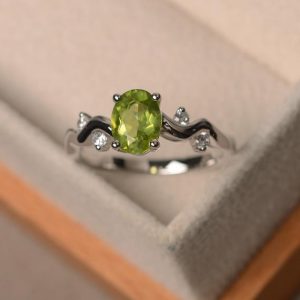 Peridot ring, engagement ring, natural peridot, oval cut peridot ring, green gemstone ring | Natural genuine Array rings, simple unique alternative gemstone engagement rings. #rings #jewelry #bridal #wedding #jewelryaccessories #engagementrings #weddingideas #affiliate #ad