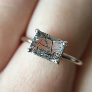 7×5 Emerald Cut Tourmalinated Quartz Solitaire Ring, Black Rutilated Quartz Engagement Ring, East West Setting, 14k Solid Gold, 925 Silver | Natural genuine Gemstone rings, simple unique alternative gemstone engagement rings. #rings #jewelry #bridal #wedding #jewelryaccessories #engagementrings #weddingideas #affiliate #ad