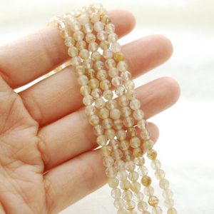 Shop Rutilated Quartz Faceted Beads! High Quality Grade A Natural Golden Rutilated Quartz Semi-Precious Gemstone FACETED Round Beads – 4mm – 15.5" strand | Natural genuine faceted Rutilated Quartz beads for beading and jewelry making.  #jewelry #beads #beadedjewelry #diyjewelry #jewelrymaking #beadstore #beading #affiliate #ad