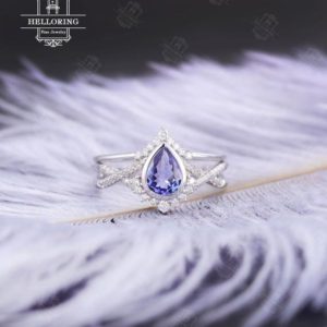 Shop Tanzanite Jewelry! Tanzanite Engagement ring set white gold Vintage wedding ring Pear cut Art deco Curved diamond Moissanite band Anniversary Promise ring | Natural genuine Tanzanite jewelry. Buy handcrafted artisan wedding jewelry.  Unique handmade bridal jewelry gift ideas. #jewelry #beadedjewelry #gift #crystaljewelry #shopping #handmadejewelry #wedding #bridal #jewelry #affiliate #ad