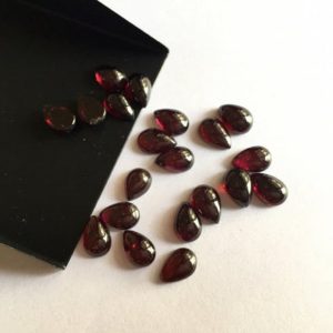 Shop Garnet Cabochons! 50 Pieces Wholesale 9x6mm Each Garnet Pear Shaped Wine Red Smooth Flat Back Loose Cabochons SKU-G14 | Natural genuine stones & crystals in various shapes & sizes. Buy raw cut, tumbled, or polished gemstones for making jewelry or crystal healing energy vibration raising reiki stones. #crystals #gemstones #crystalhealing #crystalsandgemstones #energyhealing #affiliate #ad