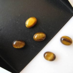 Shop Tiger Eye Cabochons! 20 Pieces 8x6mm Each Tigers Eye Oval Shaped Flat Back Smooth Loose Cabochons BB266 | Natural genuine stones & crystals in various shapes & sizes. Buy raw cut, tumbled, or polished gemstones for making jewelry or crystal healing energy vibration raising reiki stones. #crystals #gemstones #crystalhealing #crystalsandgemstones #energyhealing #affiliate #ad
