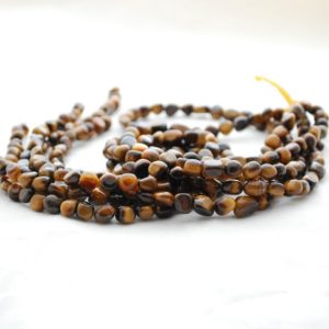 Shop Tiger Eye Chip & Nugget Beads! High Quality Grade A Natural TigerEye Semi-Precious Gemstone Tumbled Stone Nugget Pebble Beads – approx 5mm – 8mm – 15.5" strand | Natural genuine chip Tiger Eye beads for beading and jewelry making.  #jewelry #beads #beadedjewelry #diyjewelry #jewelrymaking #beadstore #beading #affiliate #ad