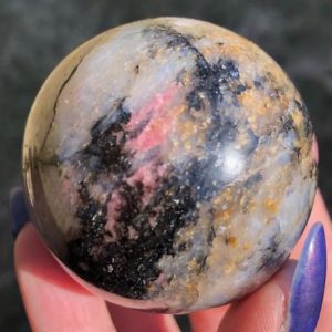 Shop Rhodonite Stones & Crystals! 2" Gemmy Cherry Blossom Rhodonite Sphere with Blue Flash  Crystal Ball #5 | Natural genuine stones & crystals in various shapes & sizes. Buy raw cut, tumbled, or polished gemstones for making jewelry or crystal healing energy vibration raising reiki stones. #crystals #gemstones #crystalhealing #crystalsandgemstones #energyhealing #affiliate #ad