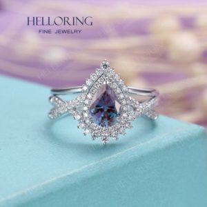 Shop Alexandrite Jewelry! Pear shaped Alexandrite engagement ring set White gold halo diamond moissanite band women Chevron ring twisted band Vintage ring | Natural genuine Alexandrite jewelry. Buy handcrafted artisan wedding jewelry.  Unique handmade bridal jewelry gift ideas. #jewelry #beadedjewelry #gift #crystaljewelry #shopping #handmadejewelry #wedding #bridal #jewelry #affiliate #ad
