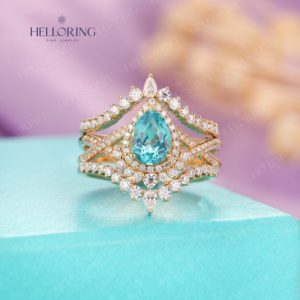 Shop Apatite Rings! Apatite engagement ring yellow gold Pear ring set halo curved wedding band women twisted engagement ring vintage Diamond moissanite ring | Natural genuine Apatite rings, simple unique alternative gemstone engagement rings. #rings #jewelry #bridal #wedding #jewelryaccessories #engagementrings #weddingideas #affiliate #ad