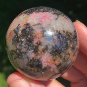 Shop Rhodonite Shapes! 1.7" Gemmy Cherry Blossom Rhodonite Sphere with Blue Flash  Crystal Ball #3 | Natural genuine stones & crystals in various shapes & sizes. Buy raw cut, tumbled, or polished gemstones for making jewelry or crystal healing energy vibration raising reiki stones. #crystals #gemstones #crystalhealing #crystalsandgemstones #energyhealing #affiliate #ad