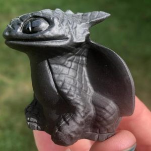 Shop Obsidian Shapes! Black Obsidian Toothless Dragon Carving  Crystal HTTYD Figurine #1 | Natural genuine stones & crystals in various shapes & sizes. Buy raw cut, tumbled, or polished gemstones for making jewelry or crystal healing energy vibration raising reiki stones. #crystals #gemstones #crystalhealing #crystalsandgemstones #energyhealing #affiliate #ad
