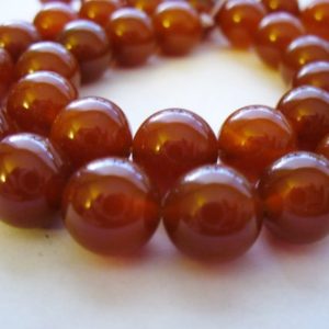 Shop Carnelian Round Beads! Carnelian Red Beads Gemstone Round 10mm | Natural genuine round Carnelian beads for beading and jewelry making.  #jewelry #beads #beadedjewelry #diyjewelry #jewelrymaking #beadstore #beading #affiliate #ad