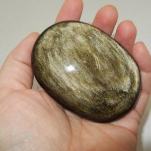 Shop Golden Obsidian Stones & Crystals! Golden Sheen Obsidian palm- large | Natural genuine stones & crystals in various shapes & sizes. Buy raw cut, tumbled, or polished gemstones for making jewelry or crystal healing energy vibration raising reiki stones. #crystals #gemstones #crystalhealing #crystalsandgemstones #energyhealing #affiliate #ad