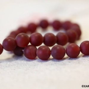 Shop Carnelian Round Beads! M/ Carnelian 10mm/ 12mm Round beads 16" strand Dyed red carnelian gemstone beads Matte finished For jewelry making | Natural genuine round Carnelian beads for beading and jewelry making.  #jewelry #beads #beadedjewelry #diyjewelry #jewelrymaking #beadstore #beading #affiliate #ad