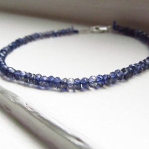 Shop Iolite Bracelets! Iolite bracelet blue silk thread silver drape stacking water sapphire | Natural genuine Iolite bracelets. Buy crystal jewelry, handmade handcrafted artisan jewelry for women.  Unique handmade gift ideas. #jewelry #beadedbracelets #beadedjewelry #gift #shopping #handmadejewelry #fashion #style #product #bracelets #affiliate #ad