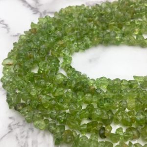 Shop Peridot Beads! Natural Peridot Irregular Nugget Chips Beads Approx 4-5mm 34" Strand | Natural genuine beads Peridot beads for beading and jewelry making.  #jewelry #beads #beadedjewelry #diyjewelry #jewelrymaking #beadstore #beading #affiliate #ad