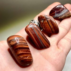 Shop Tiger Eye Stones & Crystals! Red Tiger Eye Tumbled Stones | Natural genuine stones & crystals in various shapes & sizes. Buy raw cut, tumbled, or polished gemstones for making jewelry or crystal healing energy vibration raising reiki stones. #crystals #gemstones #crystalhealing #crystalsandgemstones #energyhealing #affiliate #ad