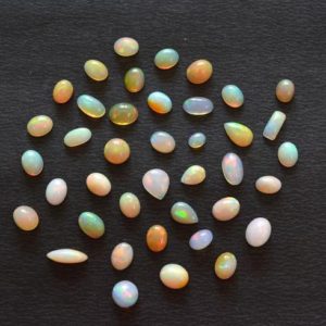 Shop Opal Cabochons! Ethiopian Opal Gemstone, Multi Fire Cabochon, Opal Stone, Mix Shape and Mix Size Ethiopian Opal, 5x7mm – 8x10mm, 10 Pcs Lot #AR0089 | Natural genuine stones & crystals in various shapes & sizes. Buy raw cut, tumbled, or polished gemstones for making jewelry or crystal healing energy vibration raising reiki stones. #crystals #gemstones #crystalhealing #crystalsandgemstones #energyhealing #affiliate #ad
