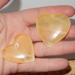 Shop Orange Calcite Stones & Crystals! Drilled Orange Calcite Heart | Natural genuine stones & crystals in various shapes & sizes. Buy raw cut, tumbled, or polished gemstones for making jewelry or crystal healing energy vibration raising reiki stones. #crystals #gemstones #crystalhealing #crystalsandgemstones #energyhealing #affiliate #ad