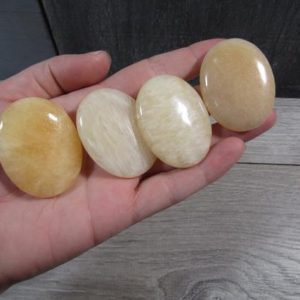 Shop Palm Stones! Orange Calcite Flat Oval Palm Stone Small E47 | Natural genuine stones & crystals in various shapes & sizes. Buy raw cut, tumbled, or polished gemstones for making jewelry or crystal healing energy vibration raising reiki stones. #crystals #gemstones #crystalhealing #crystalsandgemstones #energyhealing #affiliate #ad
