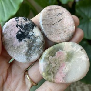 Shop Rhodonite Stones & Crystals! Rhodonite worry stone | Natural genuine stones & crystals in various shapes & sizes. Buy raw cut, tumbled, or polished gemstones for making jewelry or crystal healing energy vibration raising reiki stones. #crystals #gemstones #crystalhealing #crystalsandgemstones #energyhealing #affiliate #ad