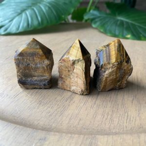 Shop Tiger Eye Points & Wands! One tiger eye point, strength, will power, courage | Natural genuine stones & crystals in various shapes & sizes. Buy raw cut, tumbled, or polished gemstones for making jewelry or crystal healing energy vibration raising reiki stones. #crystals #gemstones #crystalhealing #crystalsandgemstones #energyhealing #affiliate #ad