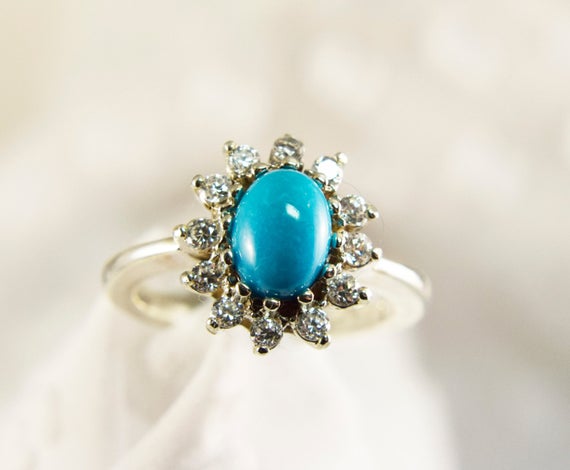 Sleeping Beauty Turquoise Ring, Usa Genuine Turquoise Gemstone, 7x5mm Oval Cabochon, Halo 0f Cz Accent Stones, Set In 925 Sterling Silver