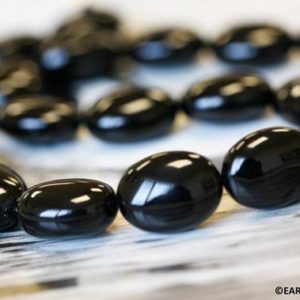 Shop Onyx Chip & Nugget Beads! L/ Black Onyx 15x20mm Oval Pebble beads 16" strand Dyed black onyx gemstone beads For jewelry making | Natural genuine chip Onyx beads for beading and jewelry making.  #jewelry #beads #beadedjewelry #diyjewelry #jewelrymaking #beadstore #beading #affiliate #ad