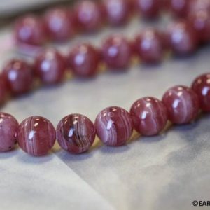 Shop Rhodochrosite Round Beads! M/ Rhodochrosite 10mm/ 8mm Smooth Round beads 15.5" strand Natural pink gemstone beads For jewelry making | Natural genuine round Rhodochrosite beads for beading and jewelry making.  #jewelry #beads #beadedjewelry #diyjewelry #jewelrymaking #beadstore #beading #affiliate #ad