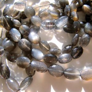 Shop Moonstone Beads! Black moonstone ovals • 7-10mm • AAA micro faceted • Natural gemstone • Grey silver golden moon glow flash | Natural genuine beads Moonstone beads for beading and jewelry making.  #jewelry #beads #beadedjewelry #diyjewelry #jewelrymaking #beadstore #beading #affiliate #ad