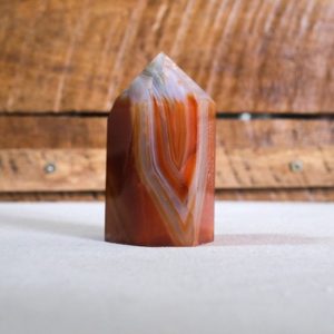 Shop Carnelian Points & Wands! Carnelian Tower | Striped Carnelian Crystal Point | Natural genuine stones & crystals in various shapes & sizes. Buy raw cut, tumbled, or polished gemstones for making jewelry or crystal healing energy vibration raising reiki stones. #crystals #gemstones #crystalhealing #crystalsandgemstones #energyhealing #affiliate #ad