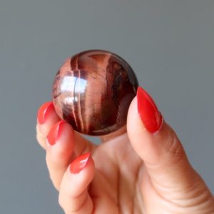 Shop Tiger Eye Shapes! Red Tigers Eye Sphere Crystal Ball | Natural genuine stones & crystals in various shapes & sizes. Buy raw cut, tumbled, or polished gemstones for making jewelry or crystal healing energy vibration raising reiki stones. #crystals #gemstones #crystalhealing #crystalsandgemstones #energyhealing #affiliate #ad