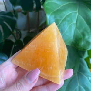 Shop Orange Calcite Shapes! Orange calcite pyramid | Natural genuine stones & crystals in various shapes & sizes. Buy raw cut, tumbled, or polished gemstones for making jewelry or crystal healing energy vibration raising reiki stones. #crystals #gemstones #crystalhealing #crystalsandgemstones #energyhealing #affiliate #ad