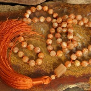 Shop Sunstone Necklaces! 9mm Sunstone AAA Knotted Mala (AAA) (84 and Guru), Necklace with a Millennial Pink Tassel 1399 | Natural genuine Sunstone necklaces. Buy crystal jewelry, handmade handcrafted artisan jewelry for women.  Unique handmade gift ideas. #jewelry #beadednecklaces #beadedjewelry #gift #shopping #handmadejewelry #fashion #style #product #necklaces #affiliate #ad