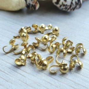 Shop Bead Tips & Knot Covers! 20pcs Raw Brass Clamshell Bead Tips | 7.5 x 4.3mm Bead Tips | Side Opening | Shop jewelry making and beading supplies, tools & findings for DIY jewelry making and crafts. #jewelrymaking #diyjewelry #jewelrycrafts #jewelrysupplies #beading #affiliate #ad