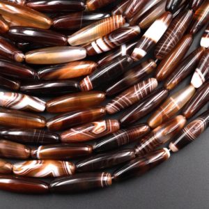 Shop Agate Chip & Nugget Beads! Natural Tibetan Agate Beads Long Slender Drum Barrel Tube Cylinder Amazing Veins Bands Stripes Brown Agate 15.5" Strand | Natural genuine chip Agate beads for beading and jewelry making.  #jewelry #beads #beadedjewelry #diyjewelry #jewelrymaking #beadstore #beading #affiliate #ad