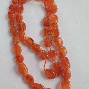 Shop Carnelian Bead Shapes! 40 Carnelian 9x7mm-12x8mm hand-cut puffed oval beads. Dark red orange colour. Approx. 13 inch strand. | Natural genuine other-shape Carnelian beads for beading and jewelry making.  #jewelry #beads #beadedjewelry #diyjewelry #jewelrymaking #beadstore #beading #affiliate #ad