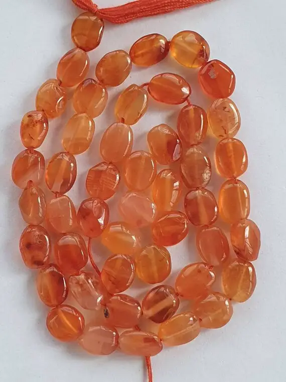 48 Carnelian 6x5mm-11x7mm Hand-cut Puffed Oval Beads. Light To Medium Orange Colour. Approx. 13 Inch Strand.