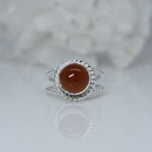 Shop Carnelian Rings! Orange Carnelian Gemstone Ring, 925 Sterling Silver Ring, Round Gemstone Ring, Twisted Bezel Set, Cabochon Gemstone, Double Twisted Band | Natural genuine Carnelian rings, simple unique handcrafted gemstone rings. #rings #jewelry #shopping #gift #handmade #fashion #style #affiliate #ad