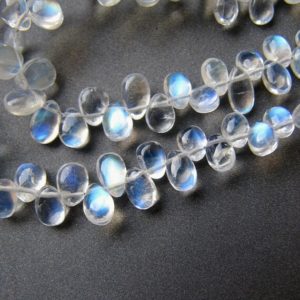 Shop Rainbow Moonstone Beads! Rainbow moonstone flat pear drops • 4-7mm • AAA+ smooth polished • Clear transparent • Strong blue fire / adularescence • Personal Favourite | Natural genuine beads Rainbow Moonstone beads for beading and jewelry making.  #jewelry #beads #beadedjewelry #diyjewelry #jewelrymaking #beadstore #beading #affiliate #ad