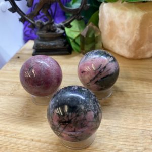Shop Rhodonite Stones & Crystals! Rhodonite 40mm sphere crystal ball orb Shelf 8 | Natural genuine stones & crystals in various shapes & sizes. Buy raw cut, tumbled, or polished gemstones for making jewelry or crystal healing energy vibration raising reiki stones. #crystals #gemstones #crystalhealing #crystalsandgemstones #energyhealing #affiliate #ad