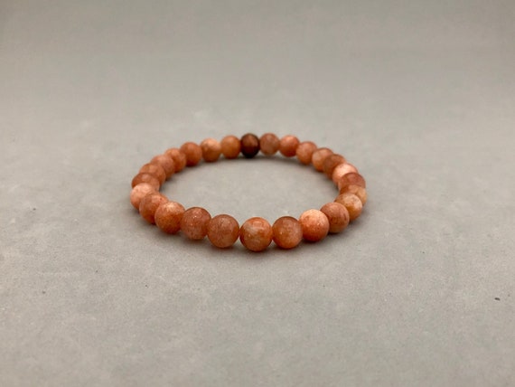 7.5mm Sunstone Stretch Bead Bracelet With Copper Accent Bead