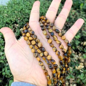 Shop Tiger Eye Chip & Nugget Beads! 1 Strand/15" Natural Yellow Tiger's Eye Healing Gemstone 6mm to 8mm Free Form Oval Tumbled Pebble Stone Bead for Earrings Jewelry Making | Natural genuine chip Tiger Eye beads for beading and jewelry making.  #jewelry #beads #beadedjewelry #diyjewelry #jewelrymaking #beadstore #beading #affiliate #ad