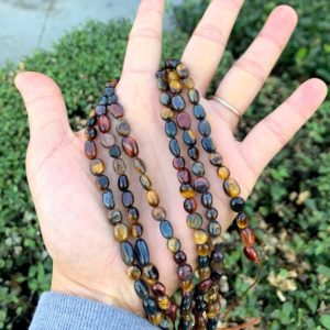 Shop Tiger Eye Chip & Nugget Beads! 1 Strand/15" Natural Multi Colors Tiger's Eye Healing Gemstone 6mm to 8mm Free Form Oval Tumbled Pebble Stone Bead for Jewelry Making | Natural genuine chip Tiger Eye beads for beading and jewelry making.  #jewelry #beads #beadedjewelry #diyjewelry #jewelrymaking #beadstore #beading #affiliate #ad