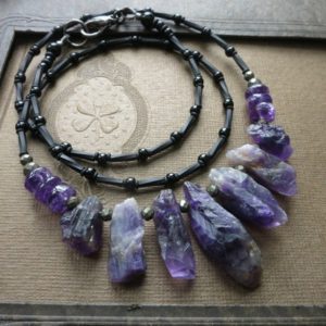 Shop Amethyst Necklaces! Rough Amethyst Crystal Necklace, rustic raw February birthstone jewelry in purple and black | Natural genuine Amethyst necklaces. Buy crystal jewelry, handmade handcrafted artisan jewelry for women.  Unique handmade gift ideas. #jewelry #beadednecklaces #beadedjewelry #gift #shopping #handmadejewelry #fashion #style #product #necklaces #affiliate #ad